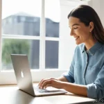 Home 3 블로그 마케팅 초보자를 위한 가이드 - A female blogger in her late 30s, with a warm and approachable smile, is intently typing on a sleek ...